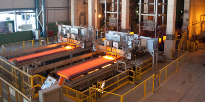 Twin-strand continuous slab caster
