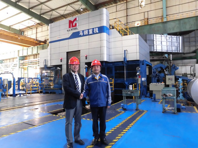 Akira Goto, Director, Primetals Technologies Japan(left) and Ding Yi, Chairman of Maanshan Iron & Steel Co., Ltd., Magang (Group) Holding Co. (right) shaking hands in front of the first RCM upgraded to a Hyper UC-Mill at Masteel´s production site in Maanshan, China.